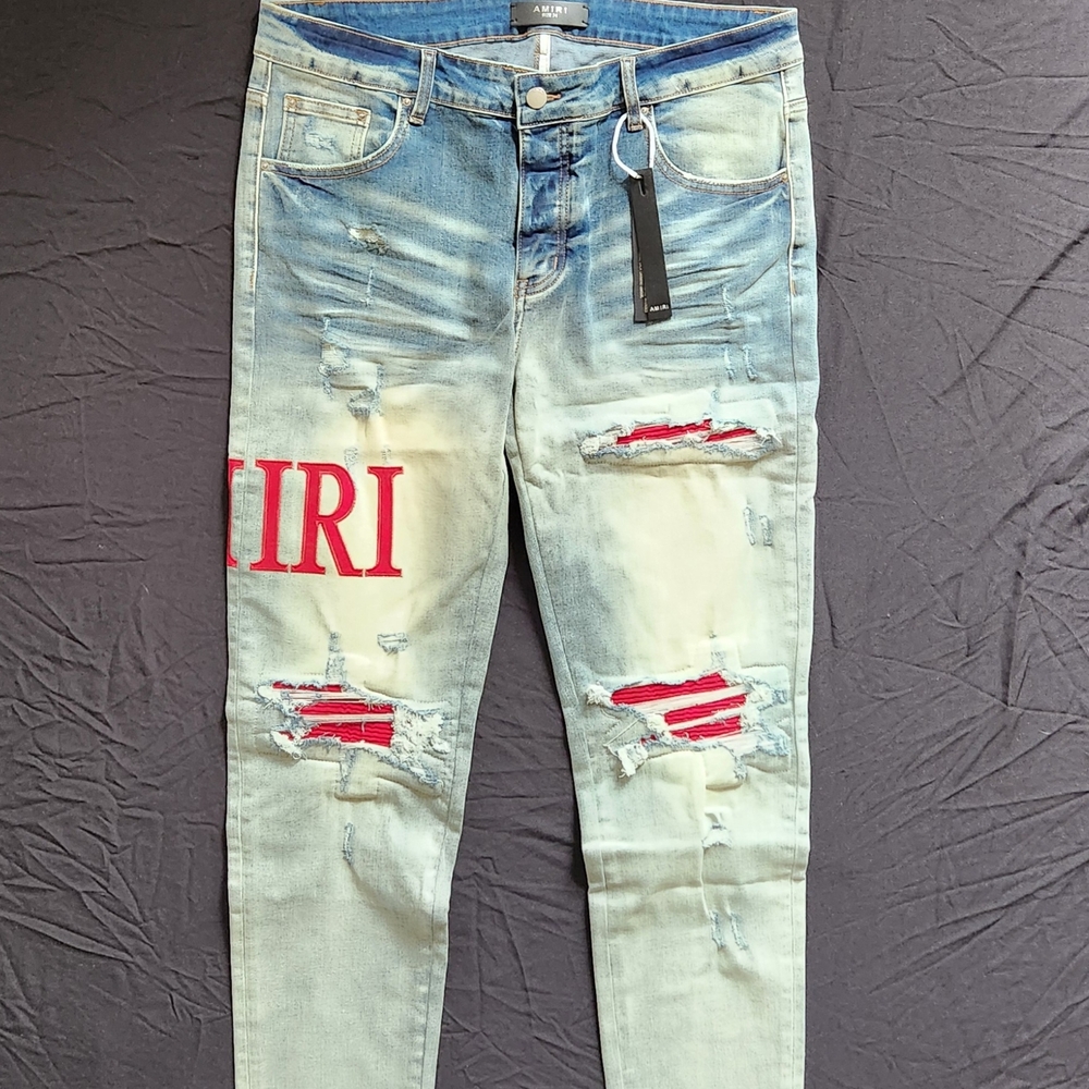 AMIRI Light Blue Washed Skinny Jeans with Red Patch Accents
